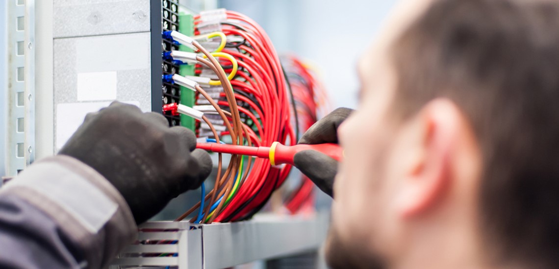 Electrician Working On Fuse Switch Box