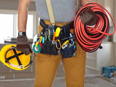 Electrician With Construction Tools And Cable
